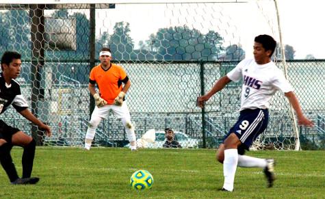 Senior Carlos Pulido runs up to ball.