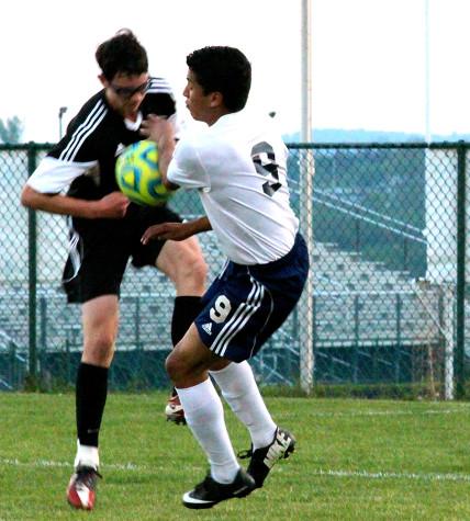 Senior Carlos Pulido tries to get ball from TA soccer player.