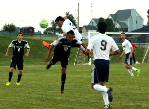 Junior Jetzon Matut-Jarquin jumps over TA player to prevent pass.