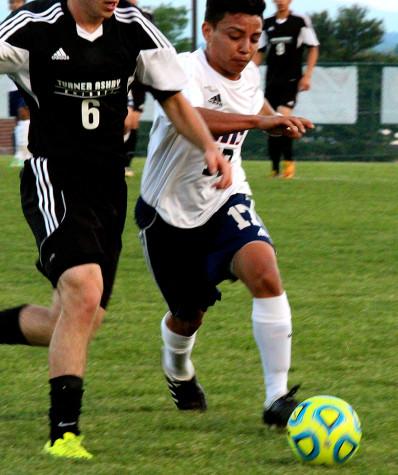 Junior Mario Murillo-Velazquez races against a TA defender for the ball.