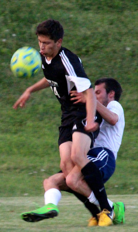 Junior Parker Strickler falls from defending against a TA soccer player.
