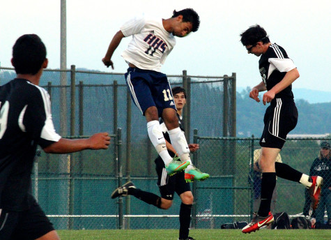 Sophomore Ameer Idan headbuts ball away from TA players.