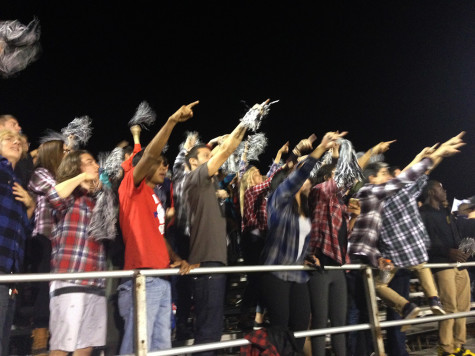 The Red Sea points in celebration at the opposing student section as the team succeeds against the TA Knights. 