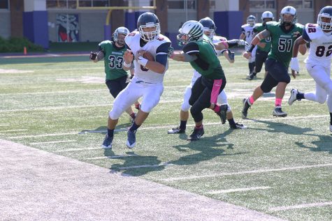 Junior AC White sidesteps a Broadway defender in an attempt to get to the sideline. White ran for a touchdown on the play, but it was called back because of a penalty. 