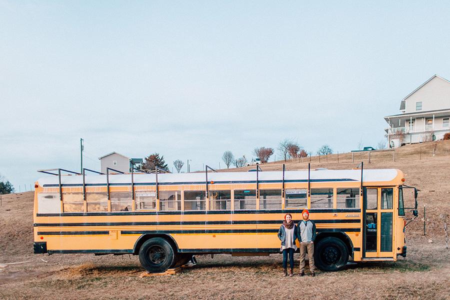 Waldrop and her husband stand outside the bus they've been renovating.