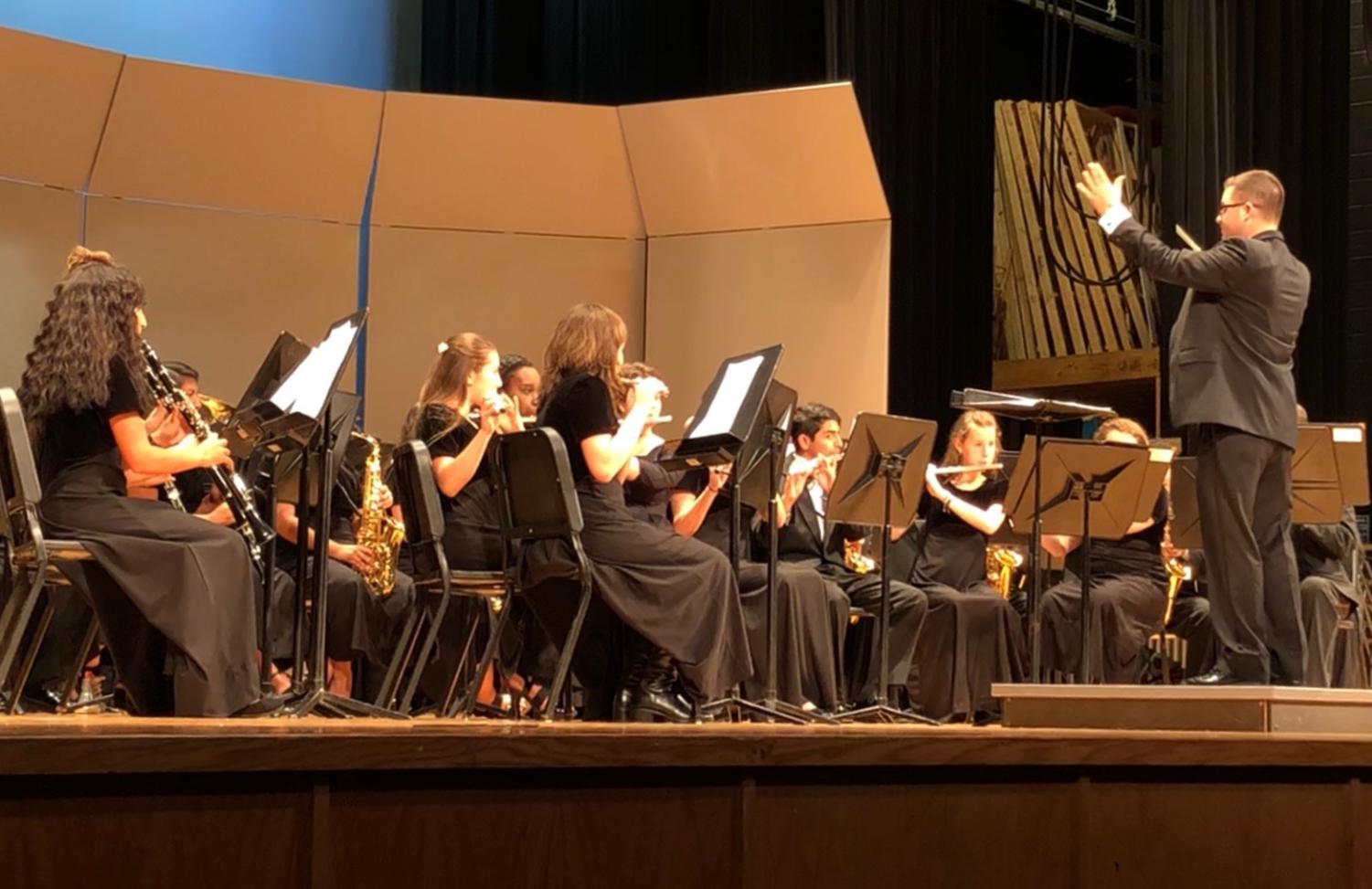 Band director Daniel Upton conducts the concert band during their performance of Gabriel Musella and Rick Rodriguez's